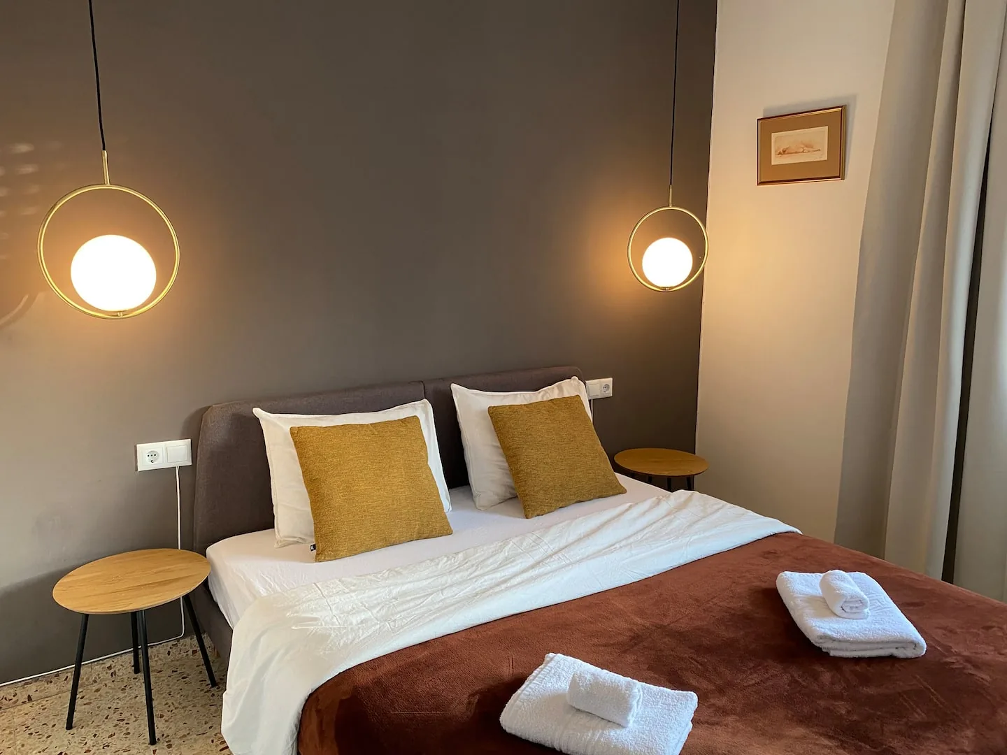 Wider view of the second bedroom with bedside tables and warm lighting